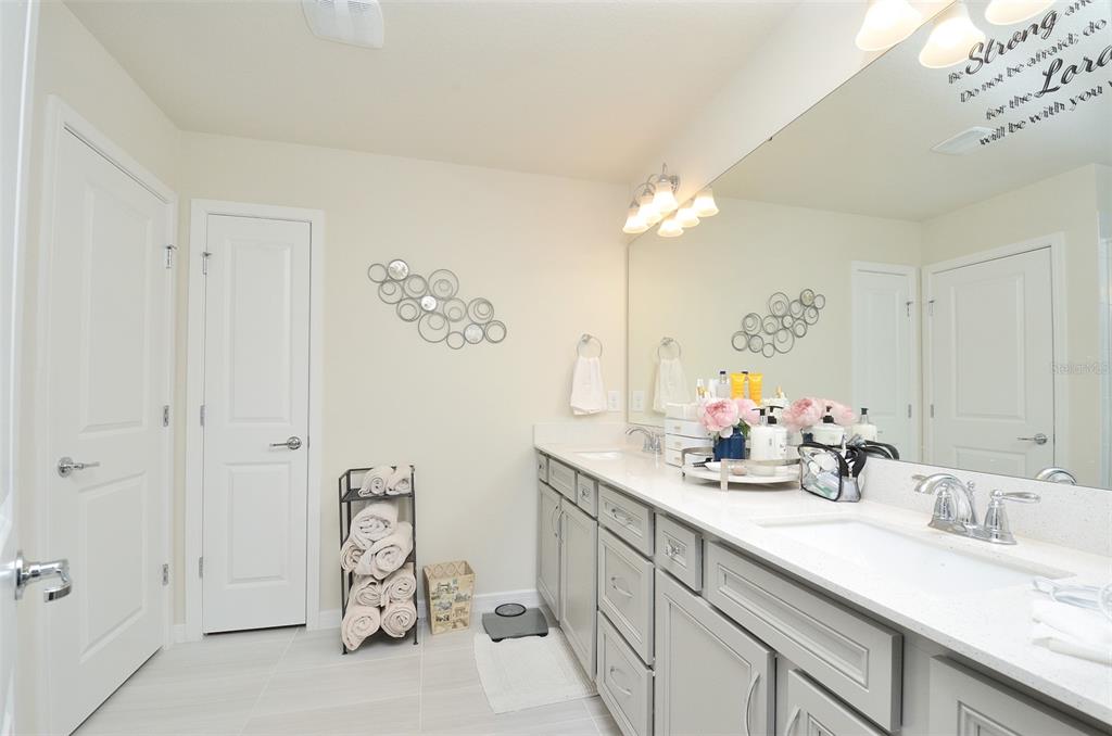 4963 Royal Point Avenue Kissimmee, FL 34746 - Photo 16 of 27 a bathroom with a double vanity sink mirror and shower