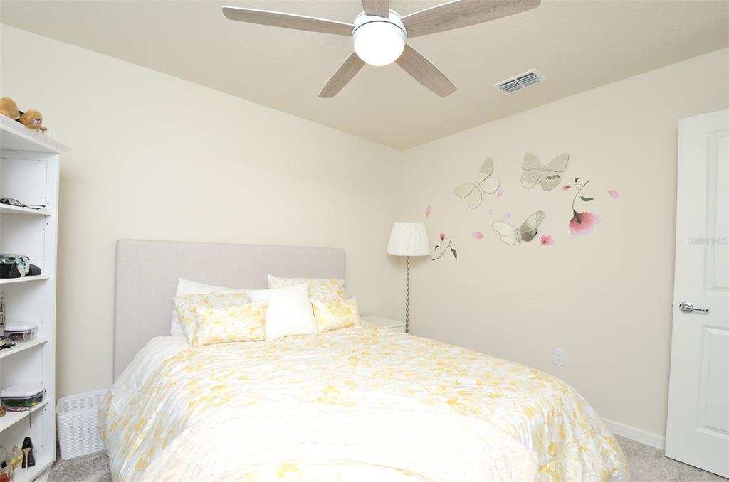 4963 Royal Point Avenue Kissimmee, FL 34746 - Photo 20 of 27 a bedroom with a bed and a chandelier
