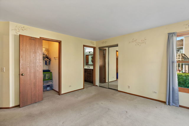 1871 Fox Run Drive, Unit A Elk Grove Village, IL 60007 - Photo 15 of 27 an empty room with closet and a window