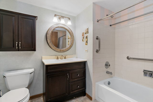 1871 Fox Run Drive, Unit A Elk Grove Village, IL 60007 - Photo 22 of 27 a bathroom with a sink a toilet and a bathtub