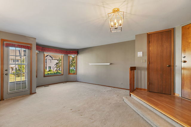 1871 Fox Run Drive, Unit A Elk Grove Village, IL 60007 - Photo 3 of 27 a view of an empty room with a window