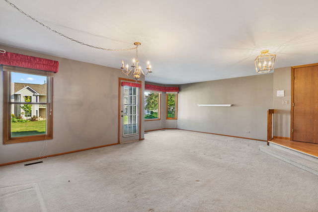 1871 Fox Run Drive, Unit A Elk Grove Village, IL 60007 - Photo 4 of 27 a view of a room with chandelier and windows