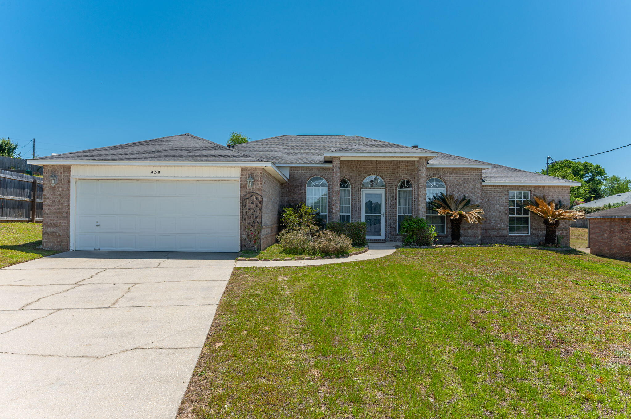 a front view of house with yard and trees