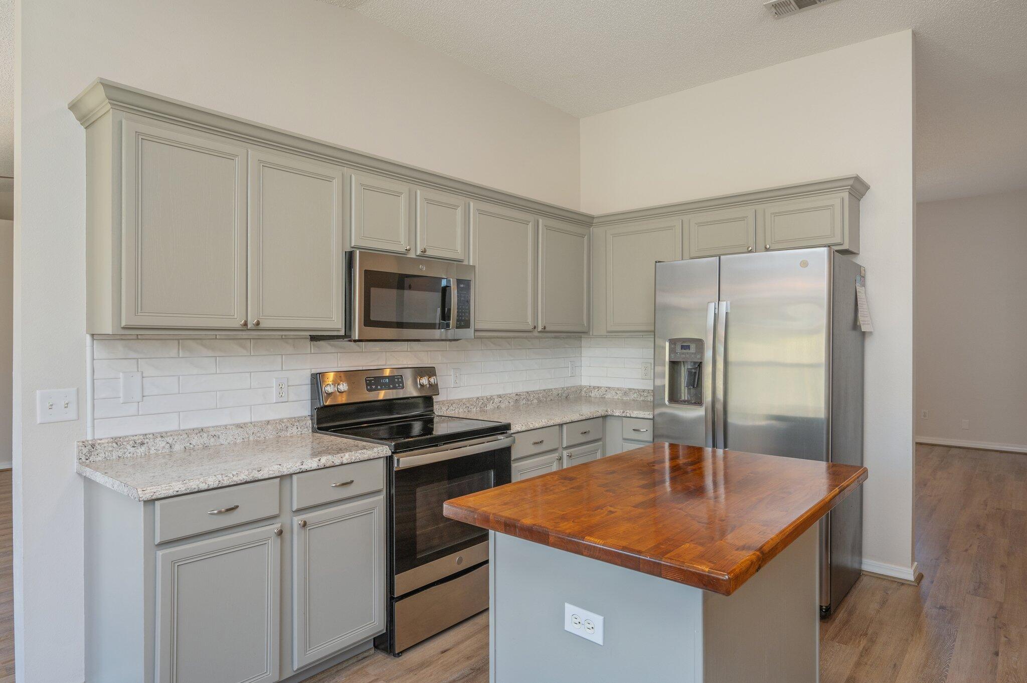 459 Jillian Drive Crestview, FL 32536 - Photo 12 of 46 a kitchen with stainless steel appliances granite countertop a sink a refrigerator and a stove
