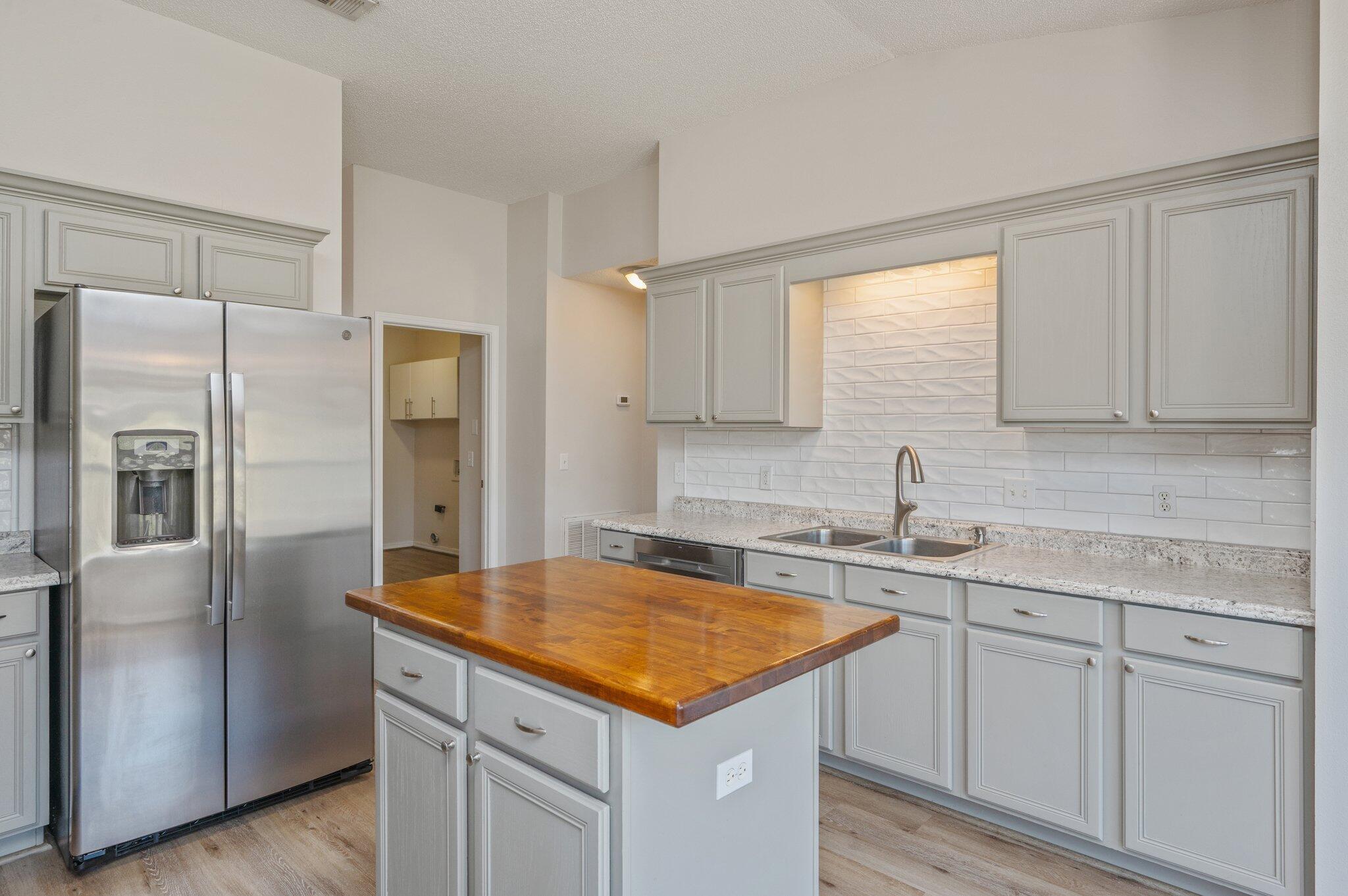 459 Jillian Drive Crestview, FL 32536 - Photo 13 of 46 a kitchen with a sink a refrigerator and cabinets