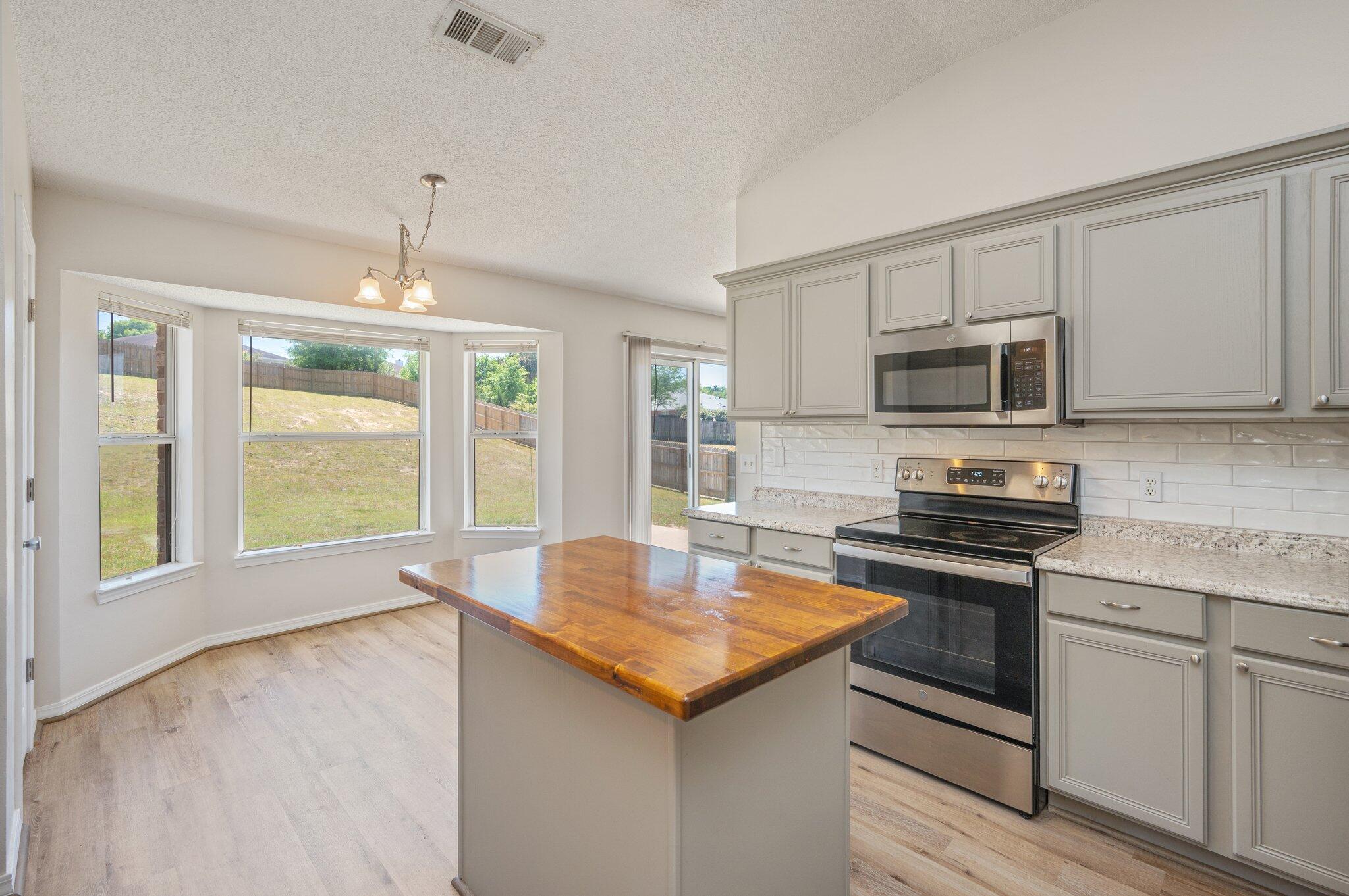 459 Jillian Drive Crestview, FL 32536 - Photo 16 of 46 a kitchen with stainless steel appliances granite countertop a stove a sink and a microwave