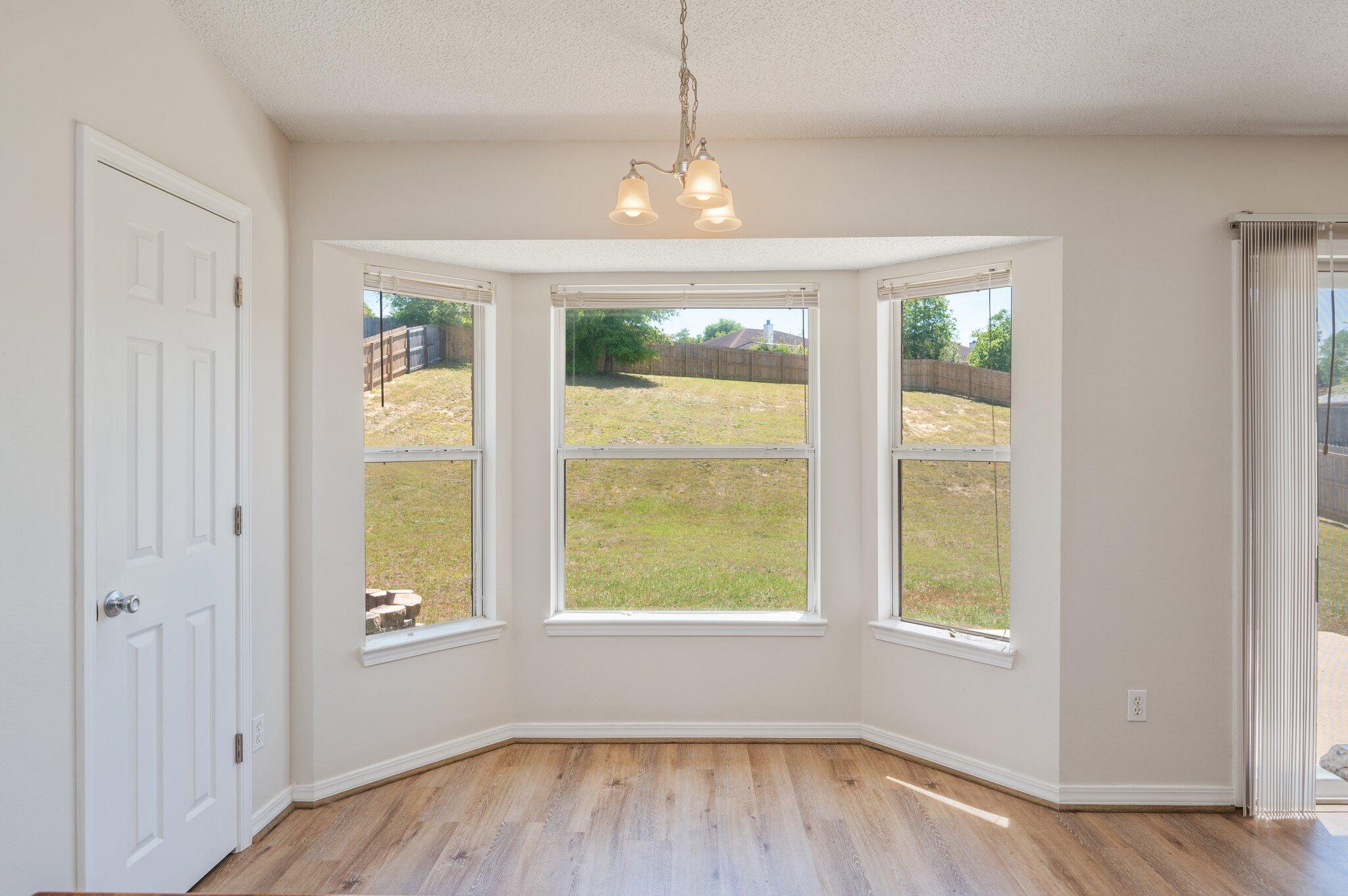 459 Jillian Drive Crestview, FL 32536 - Photo 17 of 46 a view of an empty room with wooden floor and a window