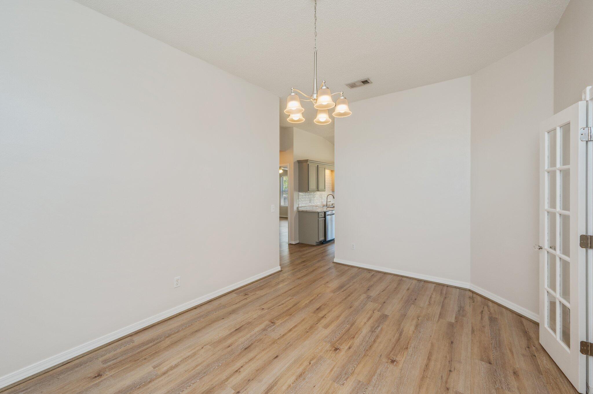 459 Jillian Drive Crestview, FL 32536 - Photo 20 of 46 a view of a big room with wooden floor and chandelier