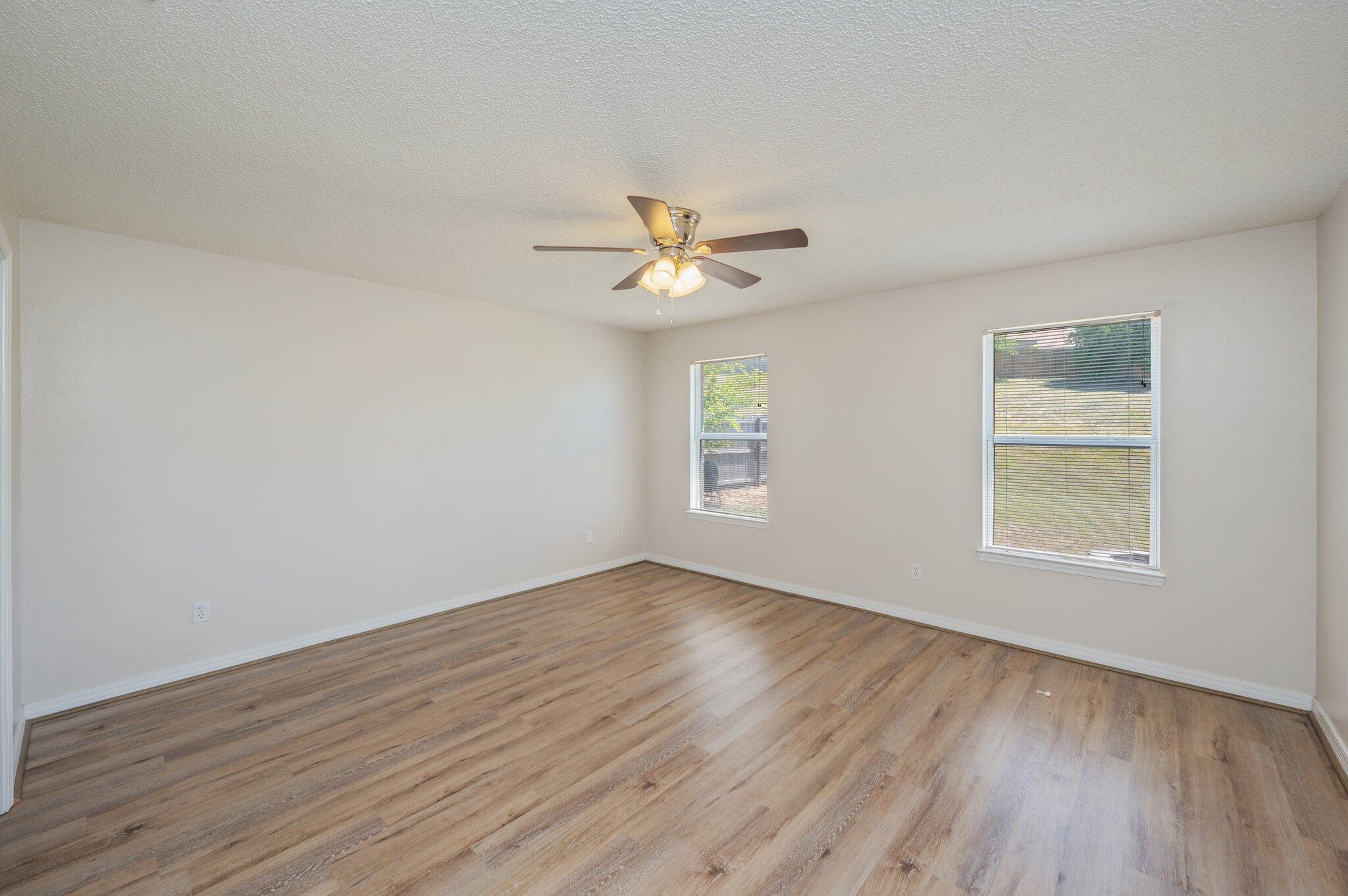 459 Jillian Drive Crestview, FL 32536 - Photo 21 of 46 an empty room with wooden floor and windows