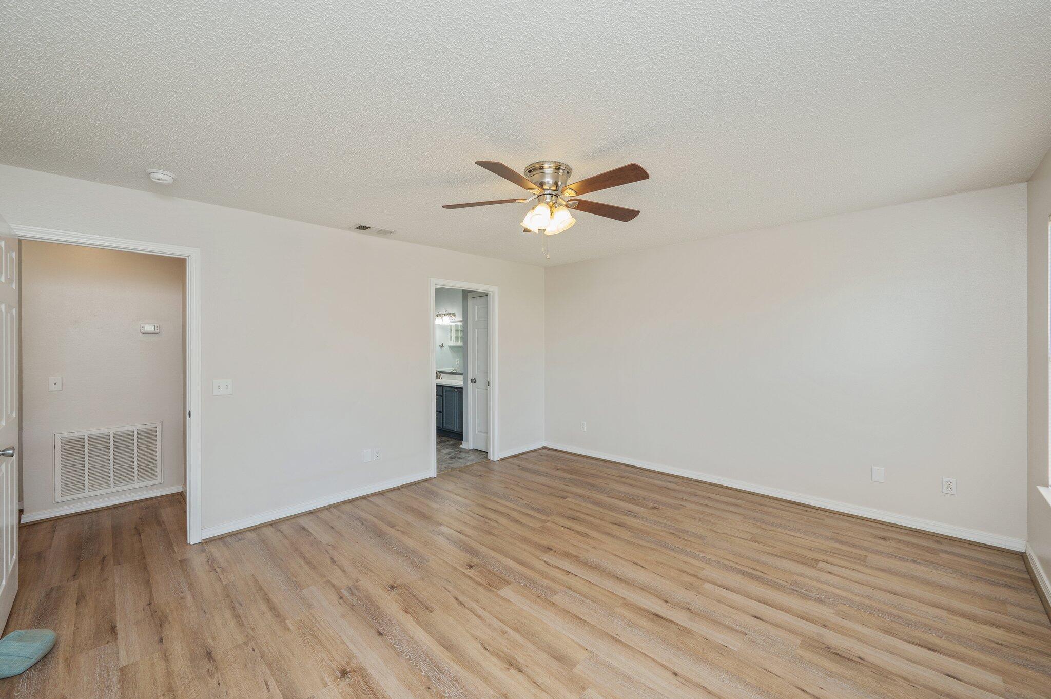 459 Jillian Drive Crestview, FL 32536 - Photo 23 of 46 an empty room with wooden floor and ceiling fan