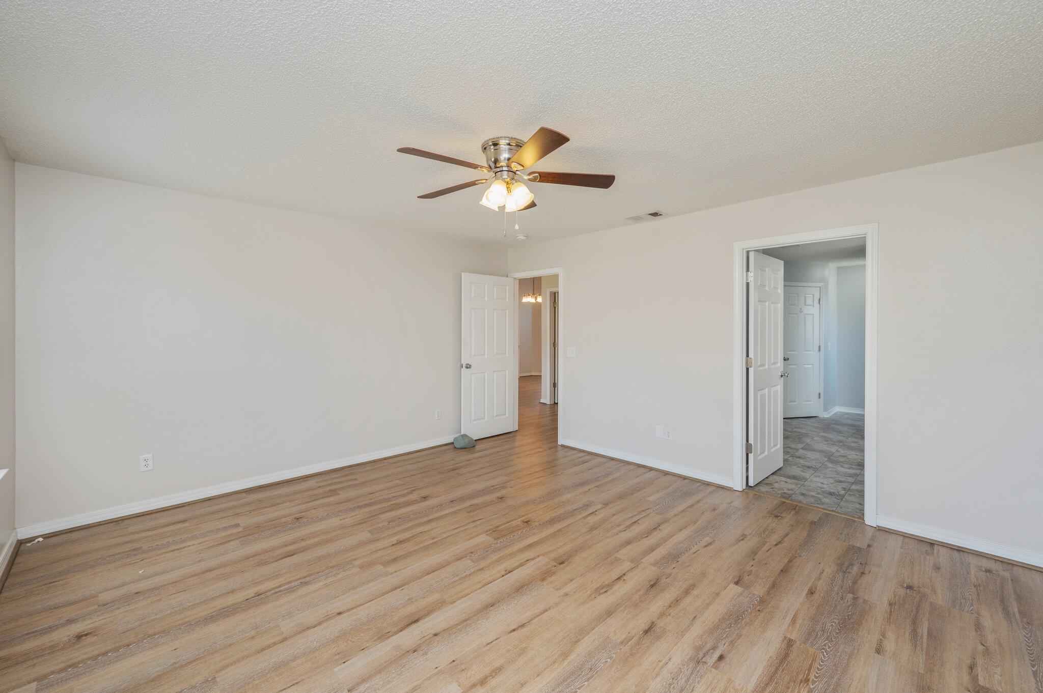 459 Jillian Drive Crestview, FL 32536 - Photo 24 of 46 a view of a room with wooden floor and a ceiling fan