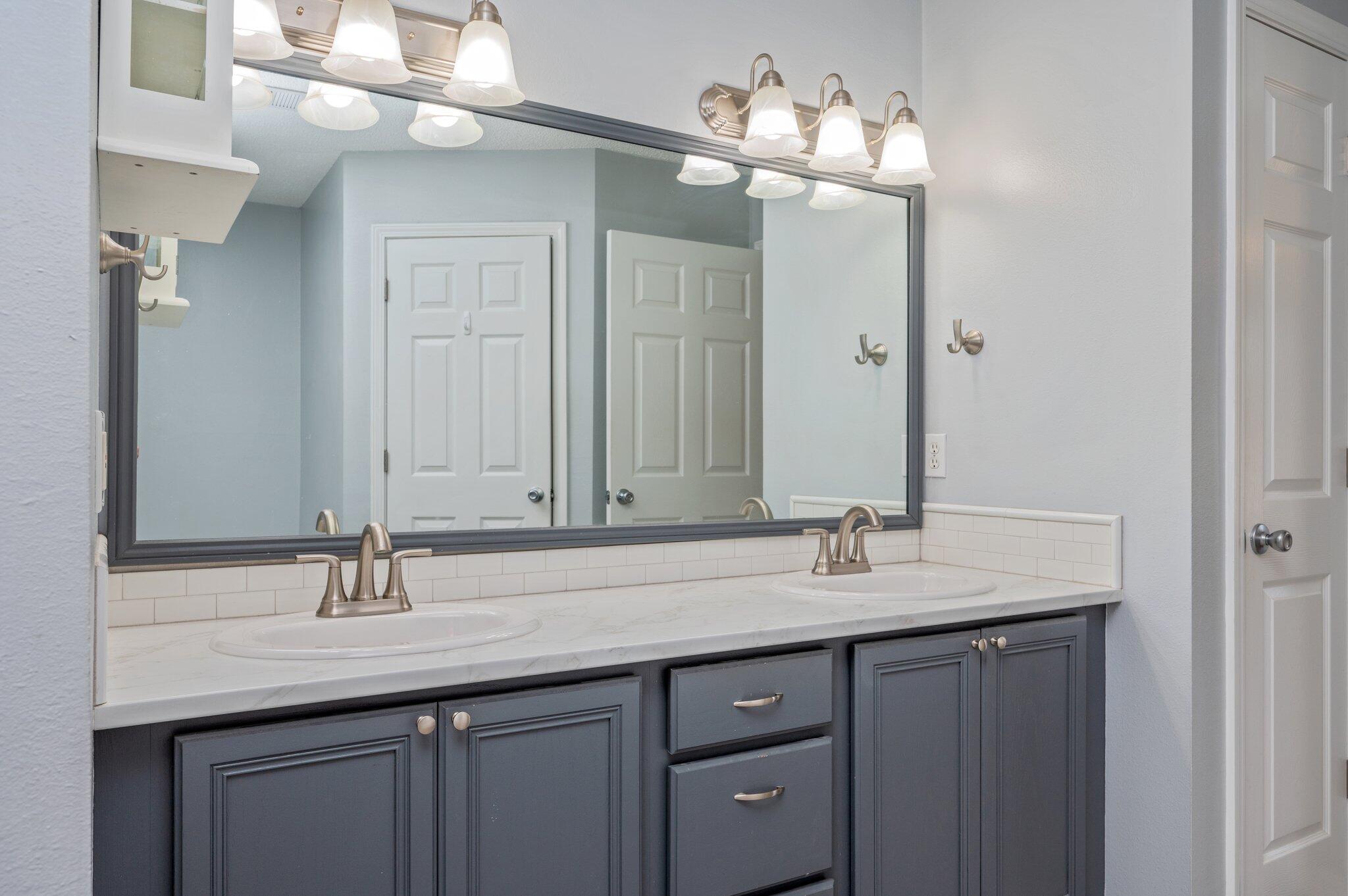 459 Jillian Drive Crestview, FL 32536 - Photo 27 of 46 a bathroom with double vanity sinks a vanity a lamp and a mirror