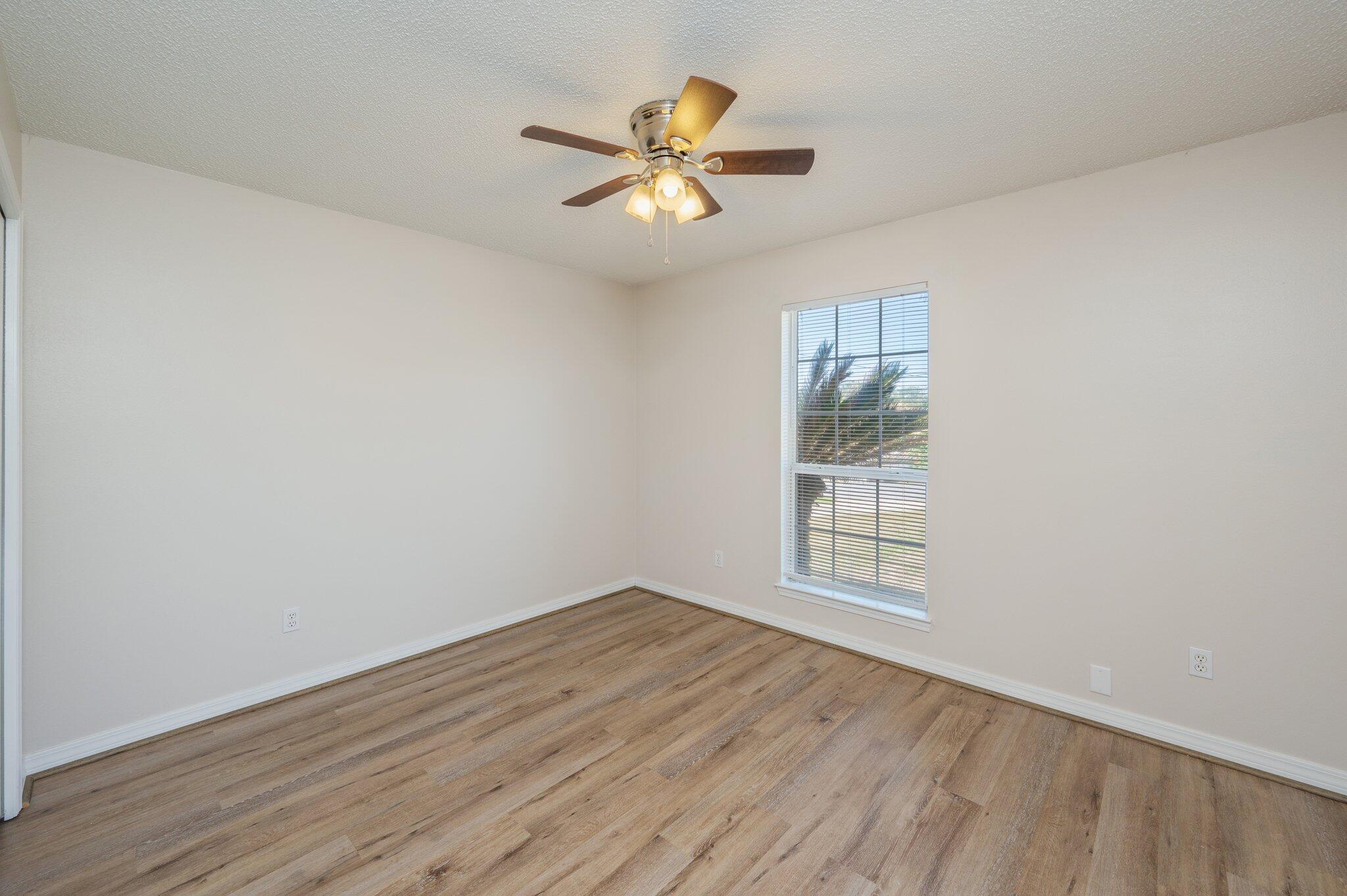 459 Jillian Drive Crestview, FL 32536 - Photo 33 of 46 wooden floor in an empty room with a window