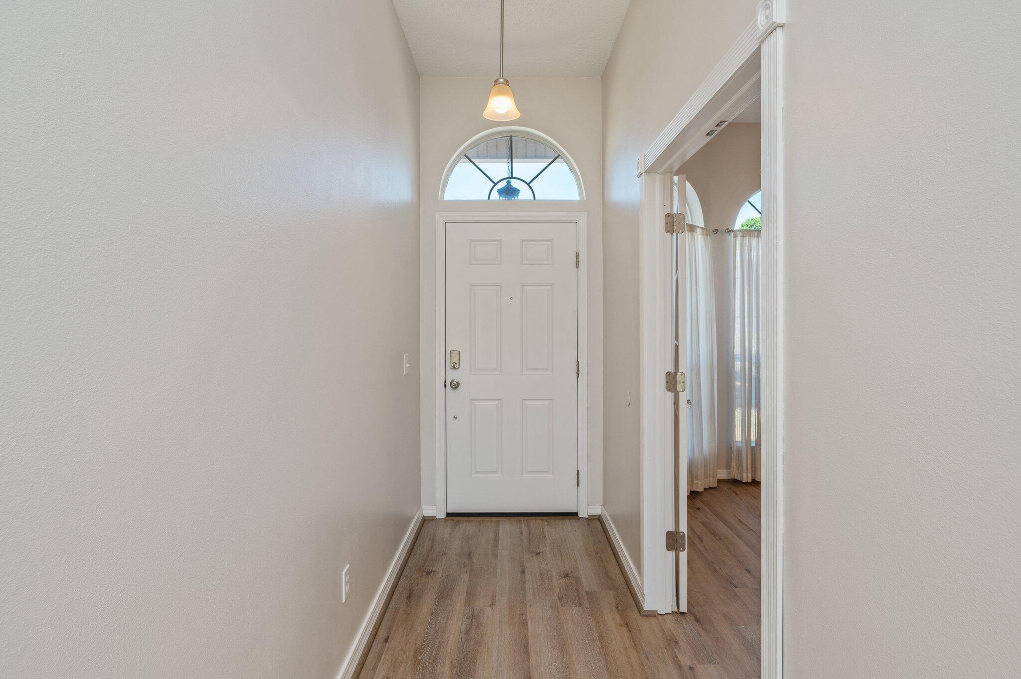 459 Jillian Drive Crestview, FL 32536 - Photo 5 of 46 an empty room with wooden floor cabinet and windows