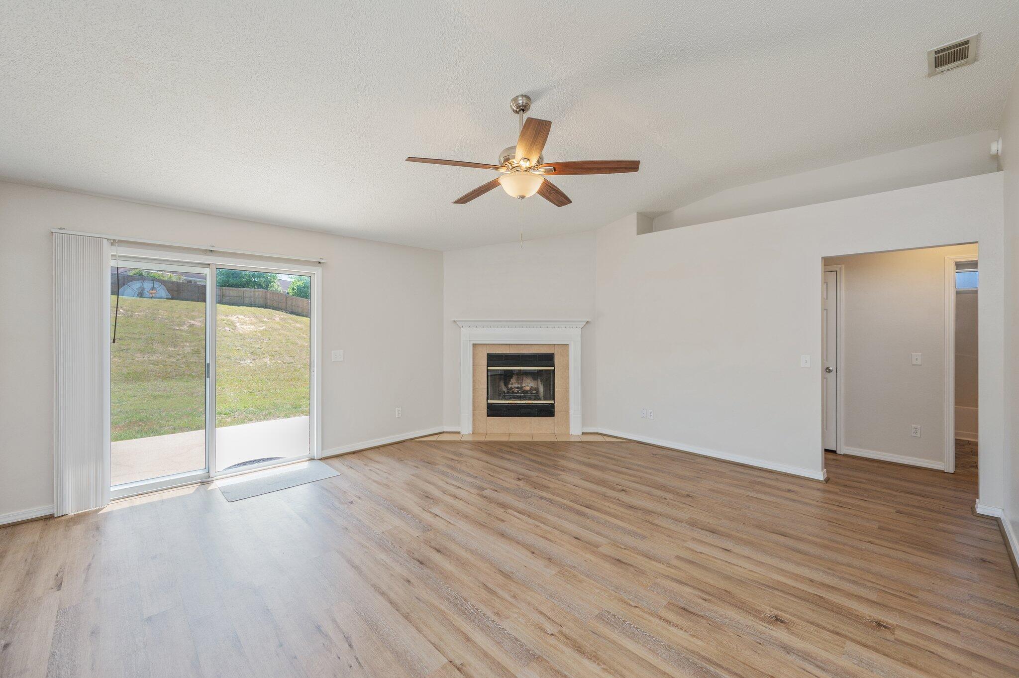 459 Jillian Drive Crestview, FL 32536 - Photo 6 of 46 an empty room with wooden floor and windows