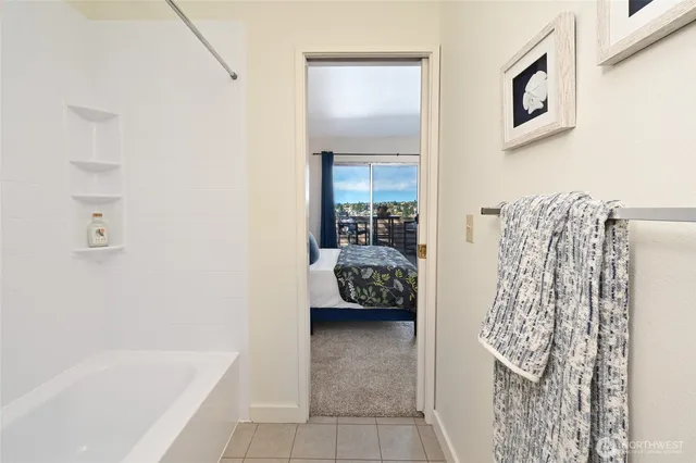 a bedroom with a bed and a painting on the wall