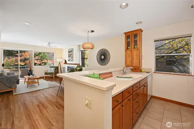 a kitchen with a table chairs and white cabinets