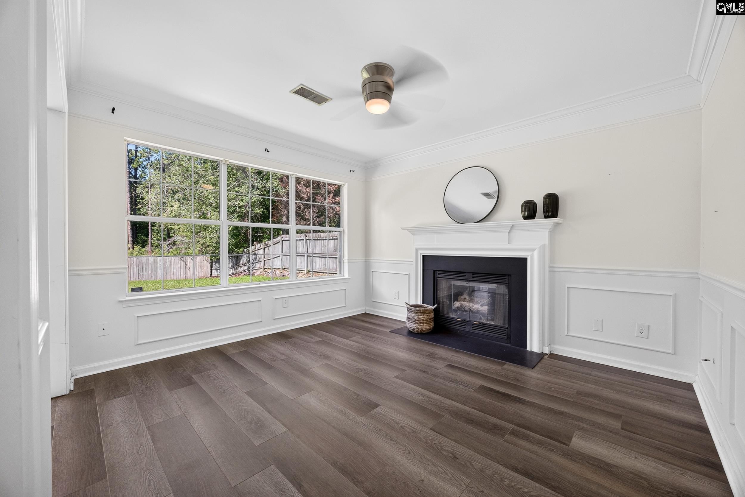 407 Sesqui Trail Columbia, SC 29223 - Photo 18 of 34 a view of an empty room with wooden floor fireplace and a window