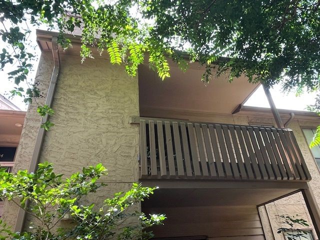 a balcony with flower plants