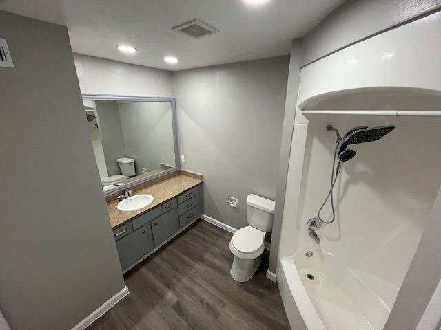 5001 Lamonte Lane, Unit 116 Houston, TX 77092 - Photo 15 of 25 a bathroom with a granite countertop sink a toilet and bathtub