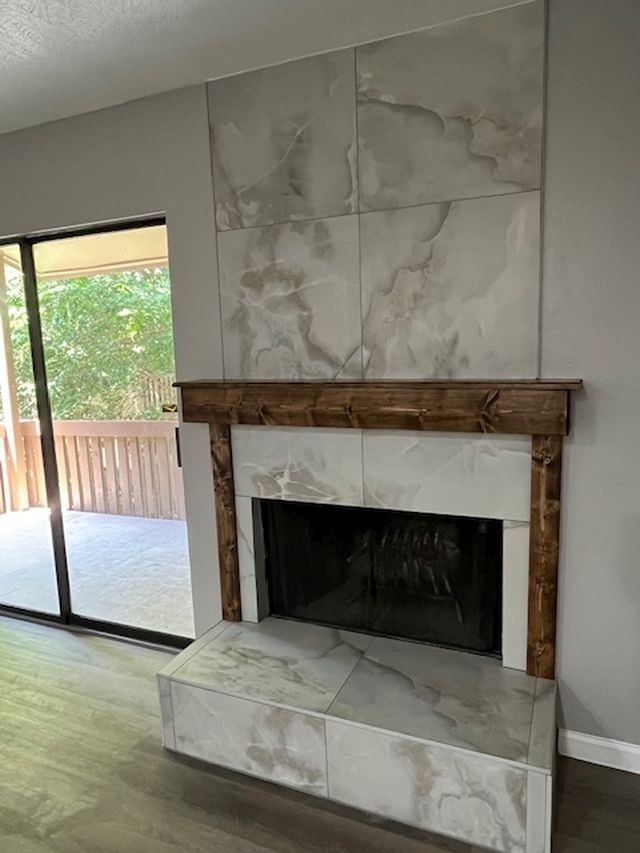 5001 Lamonte Lane, Unit 116 Houston, TX 77092 - Photo 7 of 25 a living room with a fireplace and a floor to ceiling window