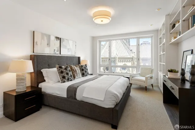 a bedroom with a large bed and a large window