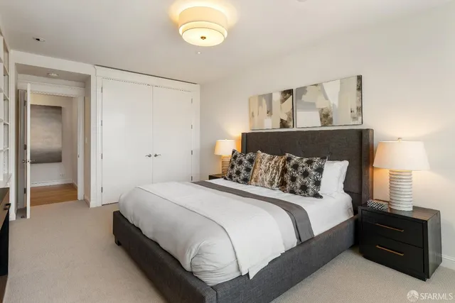 a bedroom with a bed and a lamp