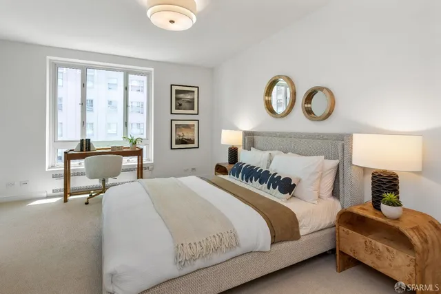 a bedroom with bed and a lamp next to a window