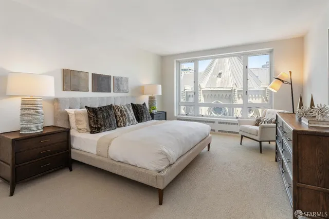 a bedroom with a bed and a large window