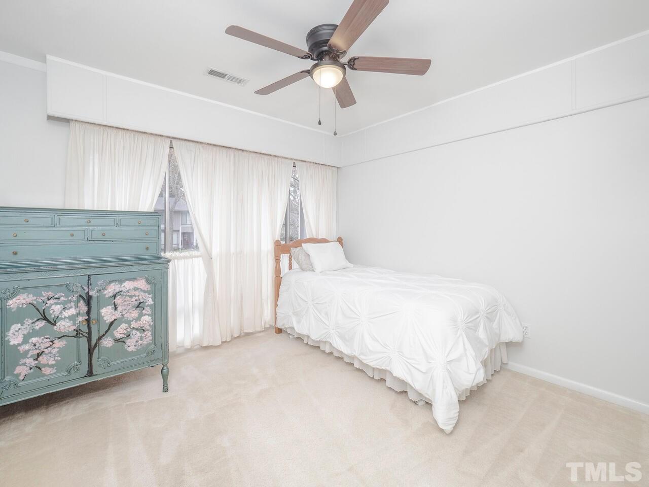 1790 Quail Ridge Road Raleigh, NC 27609 - Photo 14 of 15 a bedroom with a bed and a window