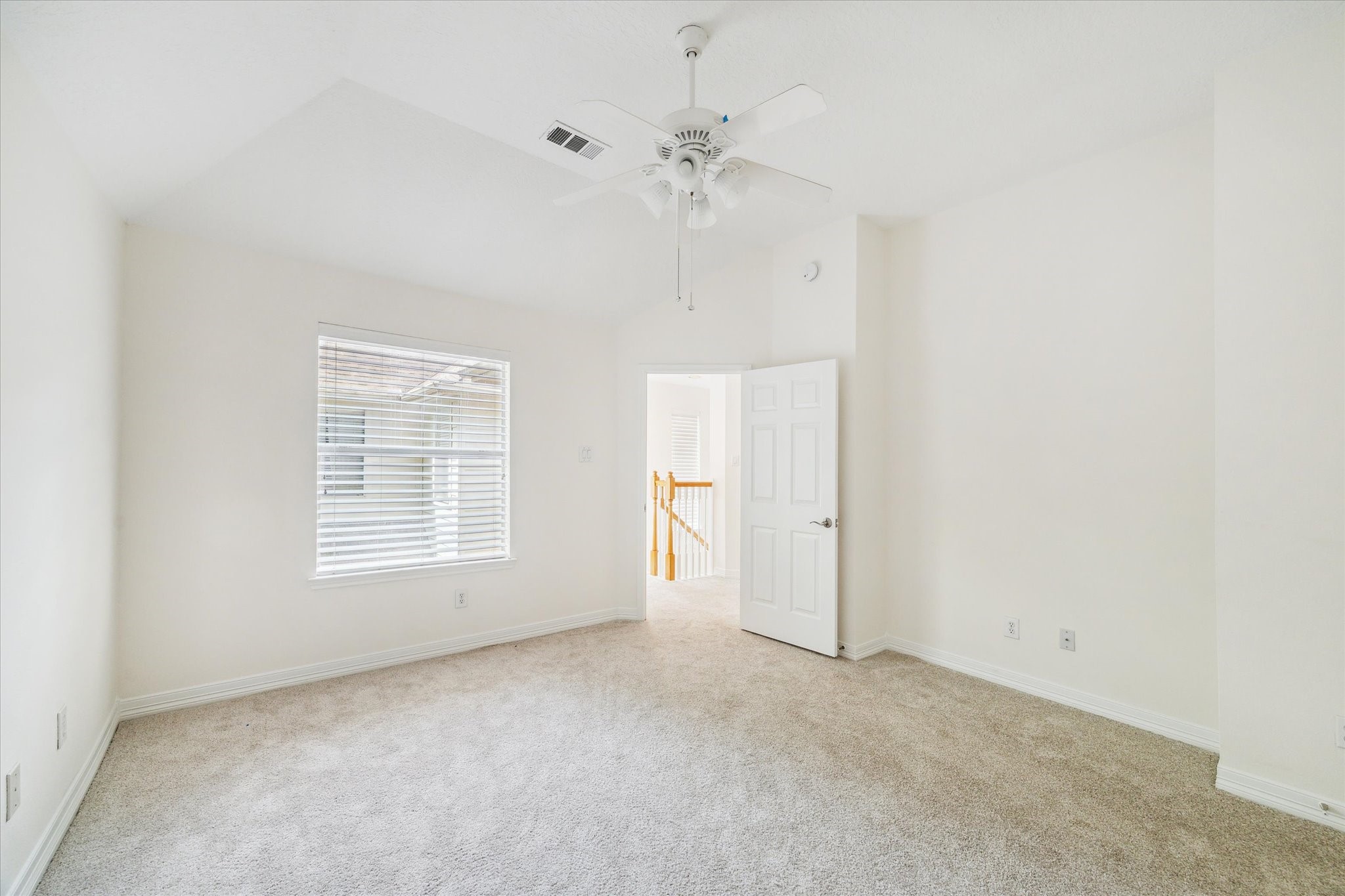 909 Reinicke Street Houston, TX 77007 - Photo 15 of 19 Another view of the upstairs bedroom. New carpet and new countertop in the ensuite bathroom.
