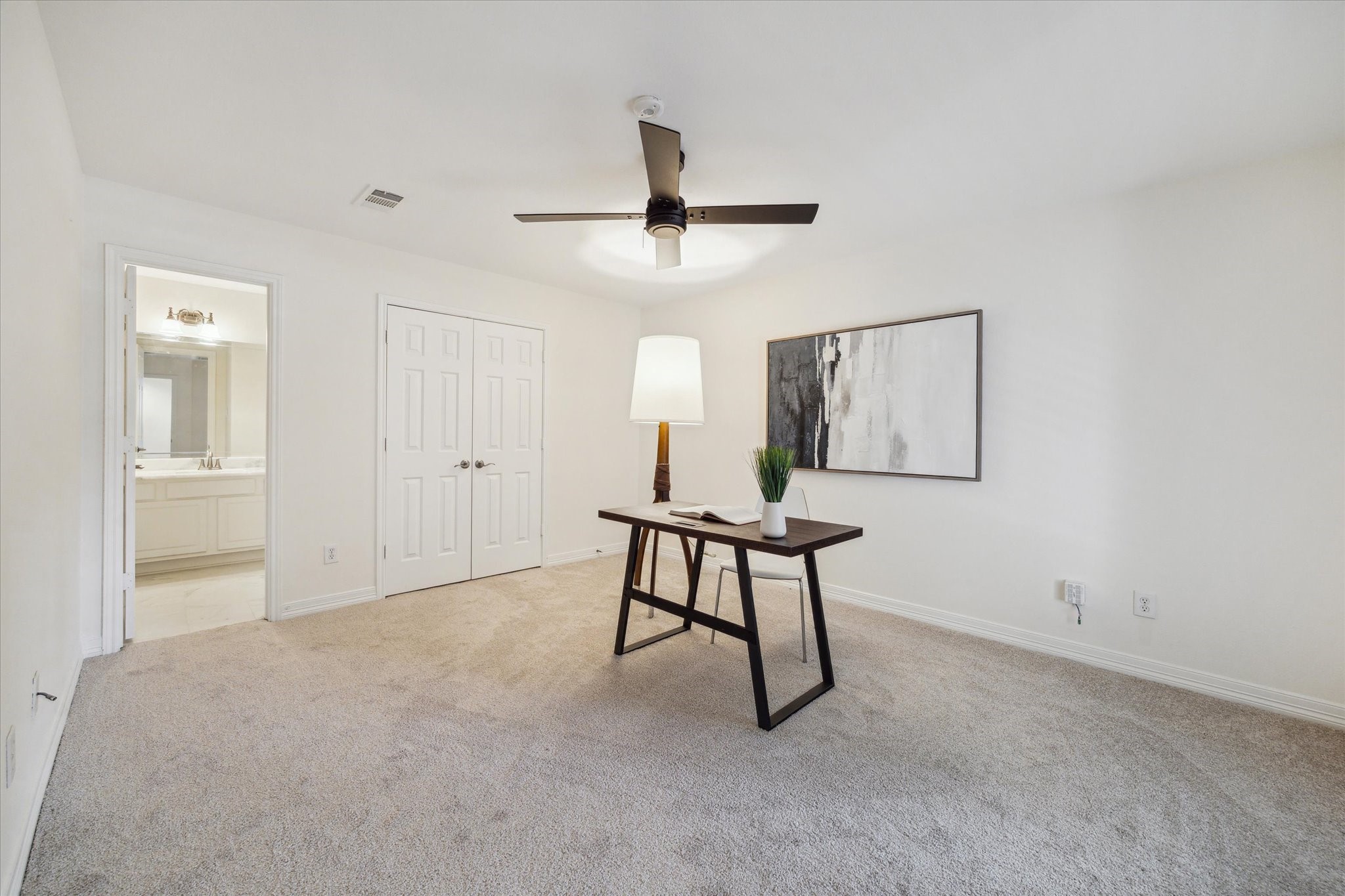 909 Reinicke Street Houston, TX 77007 - Photo 16 of 19 3rd bedroom- located on the first floor. Great for an office too! This room offers versatility, suitable for both living and work spaces. It also includes new carpet and new ceiling fan.