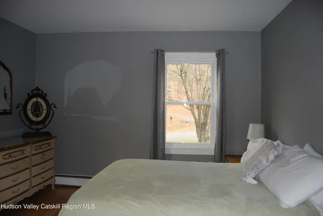 a view of bedroom with a bed and a window