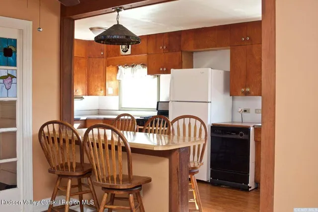 a dining room with furniture and window