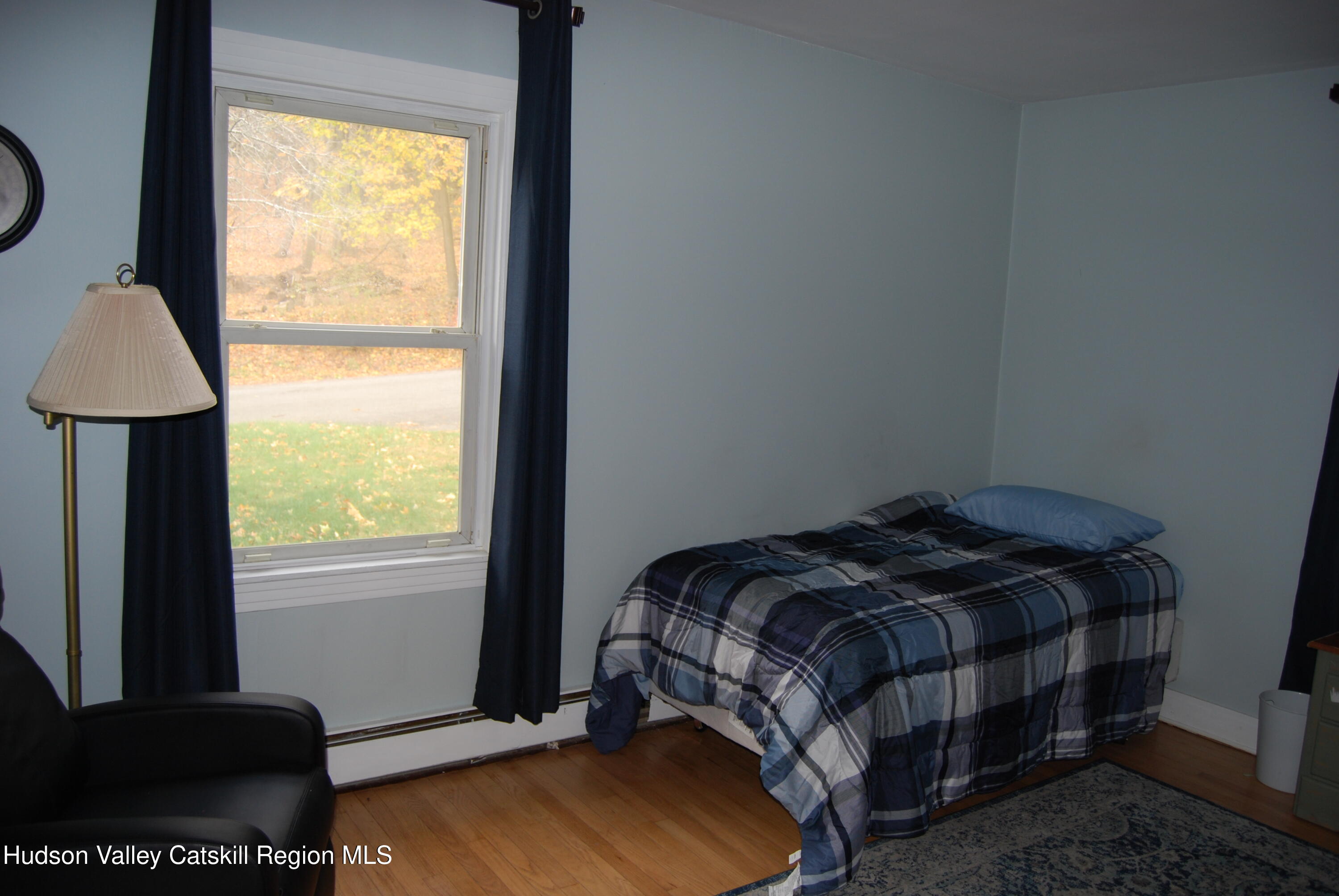7 Harmon Heights Road Chatham, NY 12037 - Photo 9 of 25 a bed sitting in a bedroom next to a window