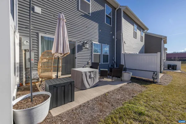 a backyard of a house with barbeque oven table and chairs