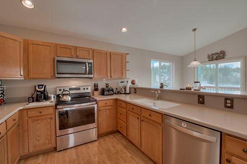 455 Apache Trail Jefferson, CO 80456 - Photo 11 of 34 a kitchen with a sink stove and microwave