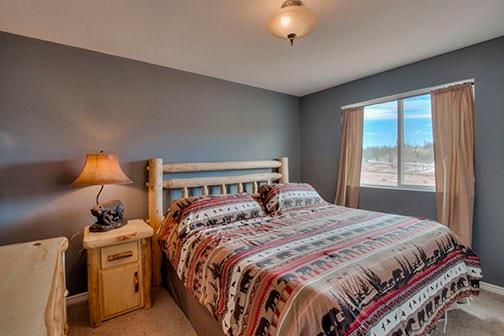 455 Apache Trail Jefferson, CO 80456 - Photo 18 of 34 a bedroom with a bed and a window