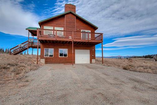 455 Apache Trail Jefferson, CO 80456 - Photo 3 of 34 a front view of a house with a ocean beach