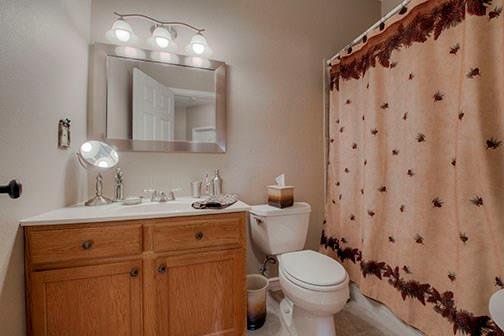 455 Apache Trail Jefferson, CO 80456 - Photo 26 of 34 a bathroom with a toilet sink and mirror