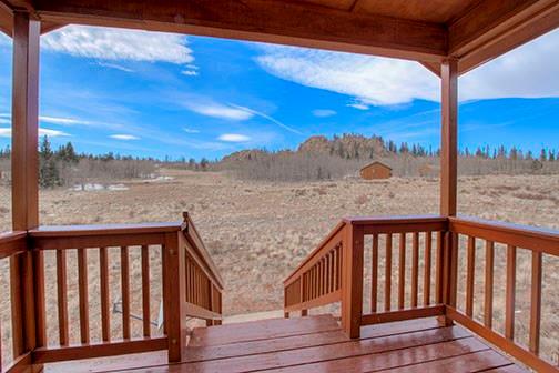 455 Apache Trail Jefferson, CO 80456 - Photo 4 of 34 a view of a balcony with wooden floor and fence