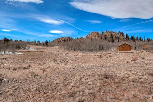 455 Apache Trail Jefferson, CO 80456 - Photo 32 of 34 a view of a lake with a mountain