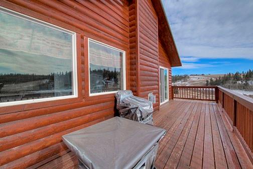 455 Apache Trail Jefferson, CO 80456 - Photo 33 of 34 a balcony with wooden floor table and chairs