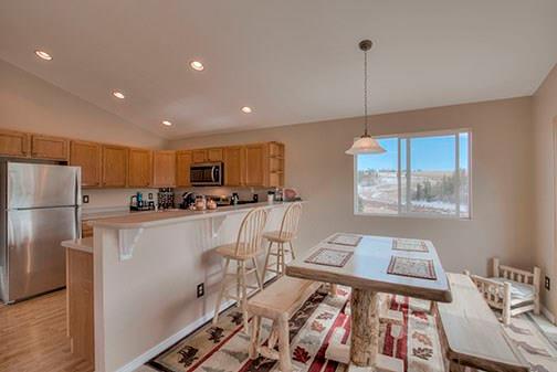 455 Apache Trail Jefferson, CO 80456 - Photo 8 of 34 a kitchen with stainless steel appliances granite countertop a refrigerator a sink dishwasher a stove and white cabinets with wooden floor
