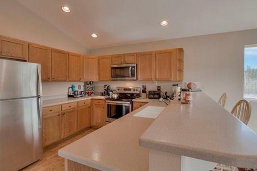 455 Apache Trail Jefferson, CO 80456 - Photo 9 of 34 a kitchen with granite countertop a refrigerator stove top oven a sink and dishwasher
