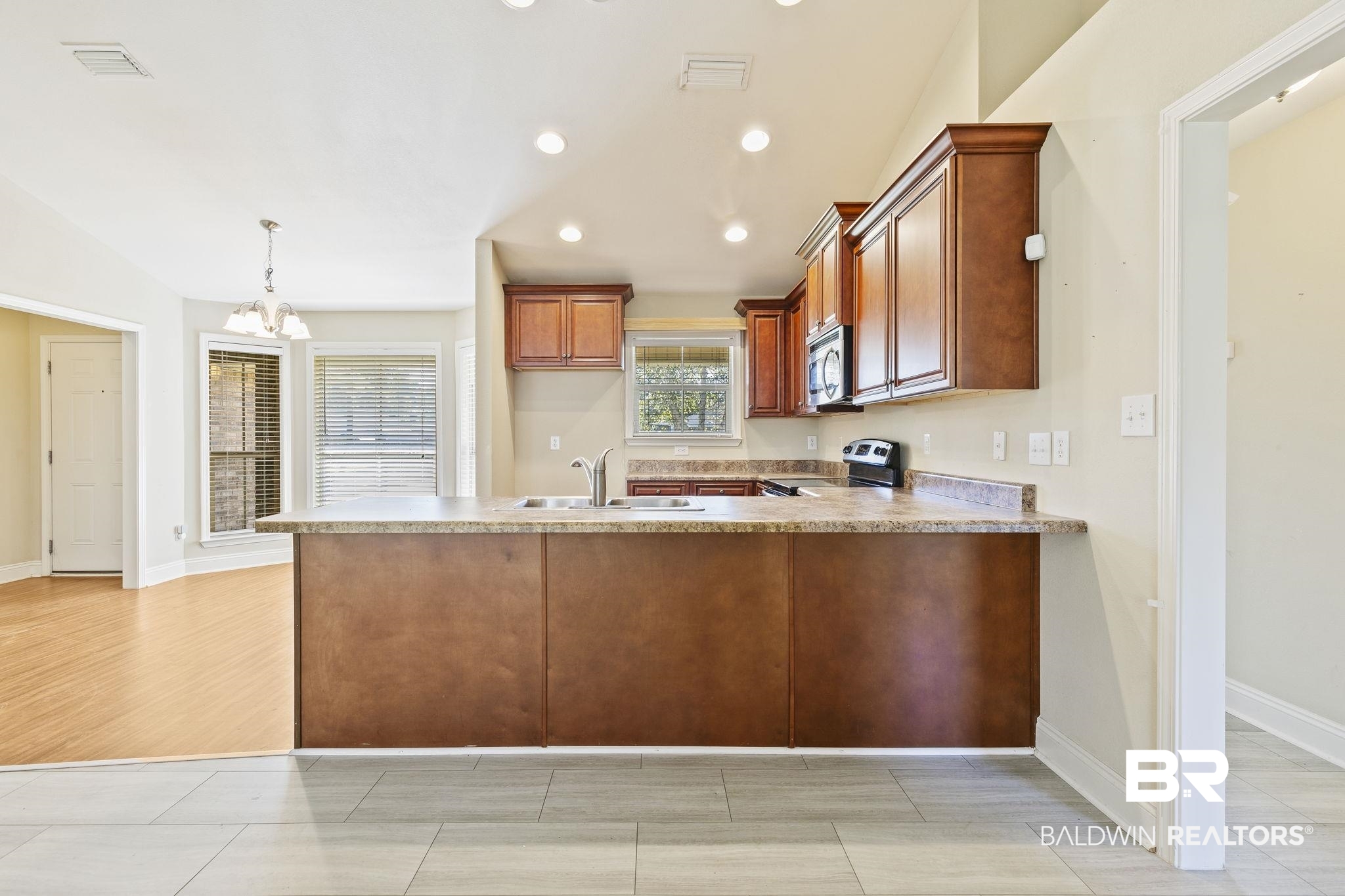 11153 Sturbridge Loop Daphne, AL 36526 - Photo 29 of 79 Kitchen featuring kitchen peninsula, appliances with stainless steel finishes, light wood-type flooring, sink, and pendant lighting