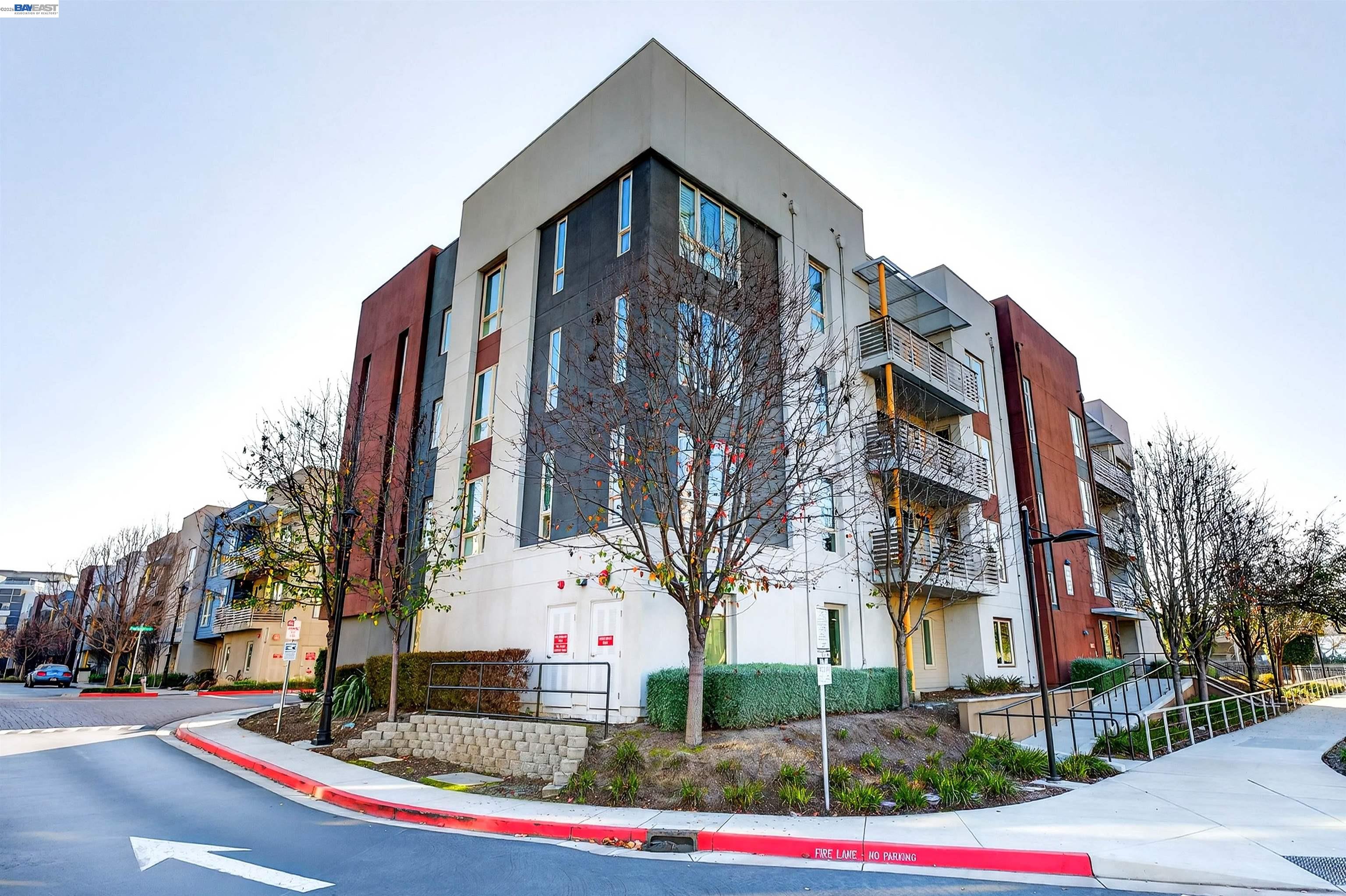 430 Montague Expressway, Unit 20 Milpitas, CA 95035 - Photo 1 of 50 a front view of a multi story residential apartment building with yard