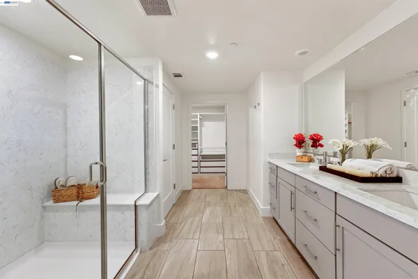 a spacious bathroom with a double vanity sink and a mirror