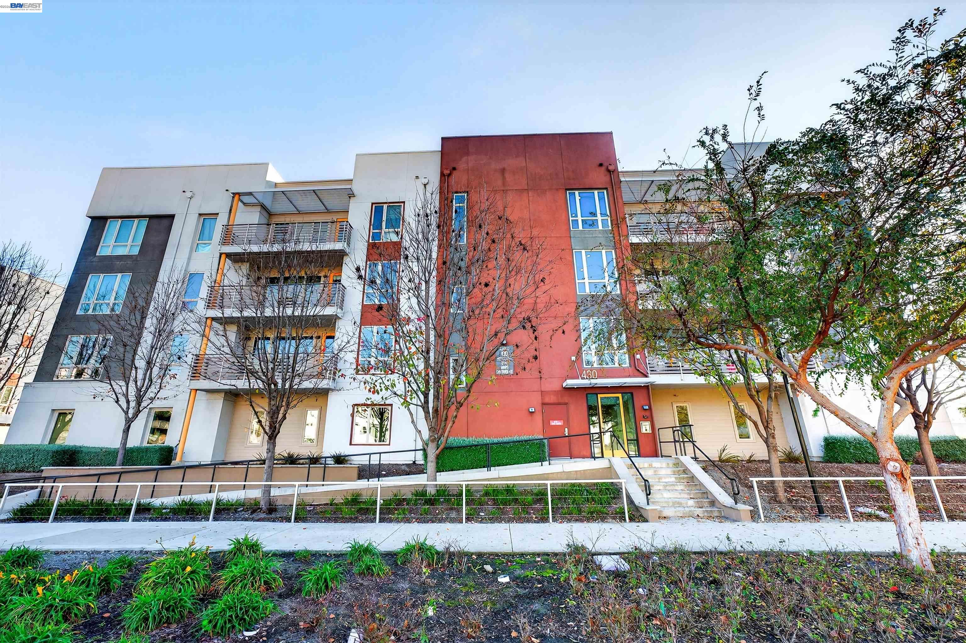 430 Montague Expressway, Unit 20 Milpitas, CA 95035 - Photo 40 of 50 a front view of a multi story residential apartment building with a yard