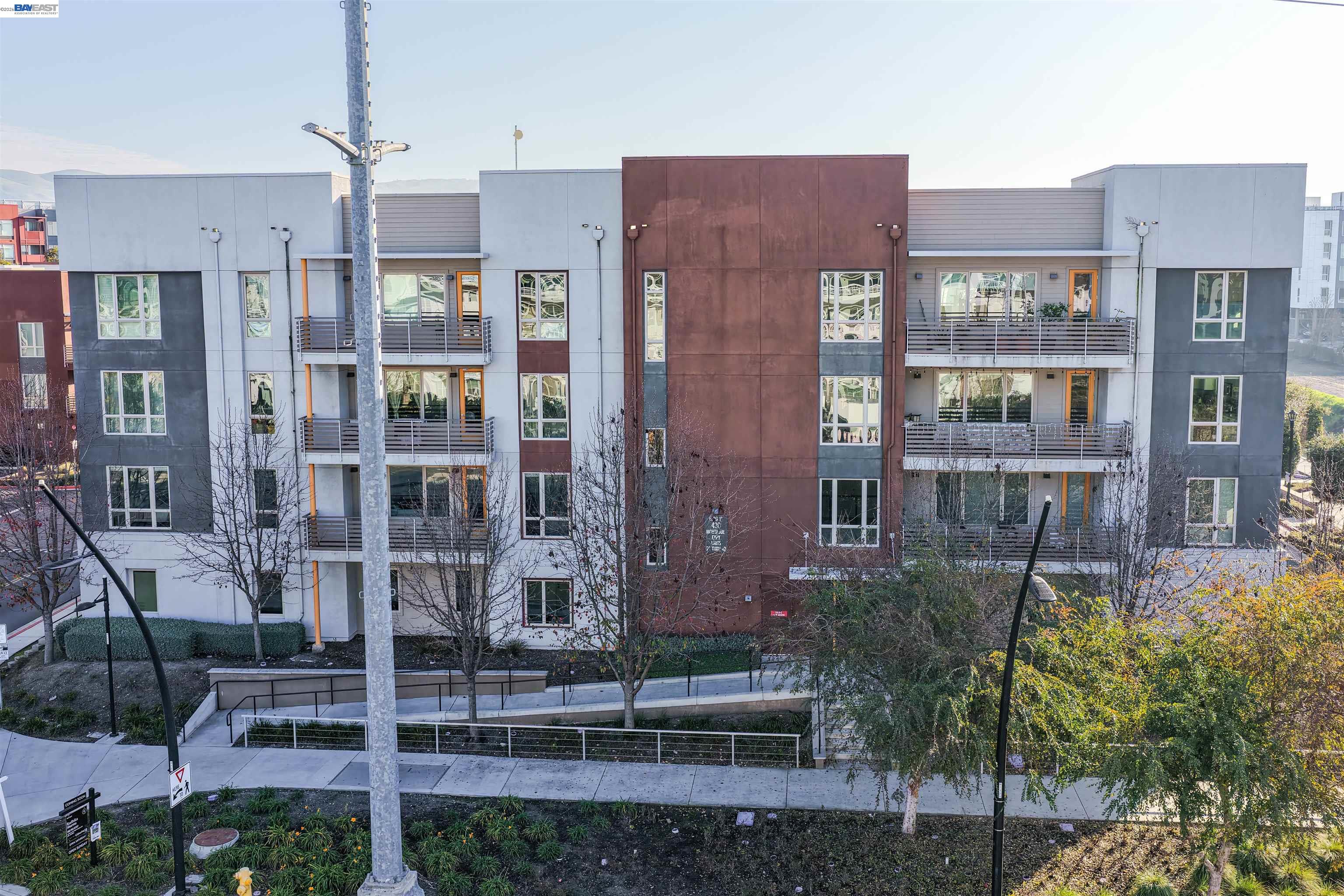 430 Montague Expressway, Unit 20 Milpitas, CA 95035 - Photo 44 of 50 a front view of a building with glass windows and plants